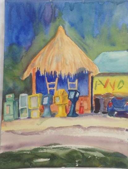 Bank of newspaper dispensers in Goodland, in front of "Island Woman"